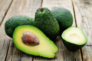 avocado on a dark wood background. tinting. selective focus